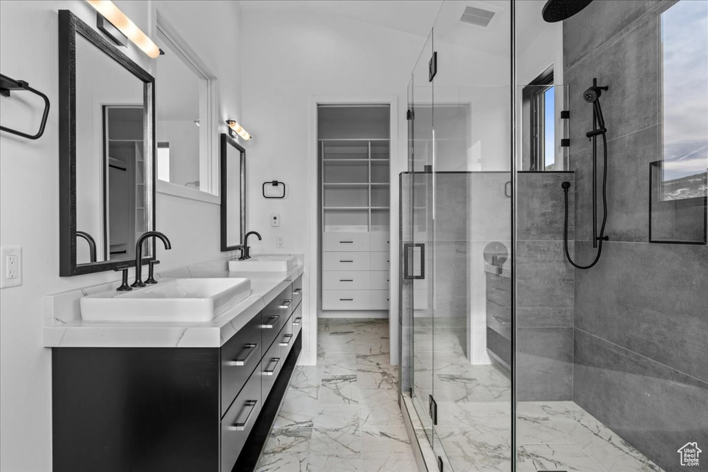 Bathroom featuring vanity and a shower with shower door