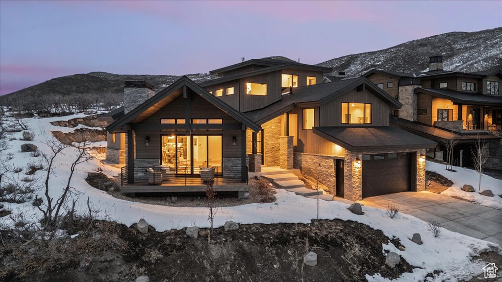 Exterior space with a mountain view, a garage, and covered porch