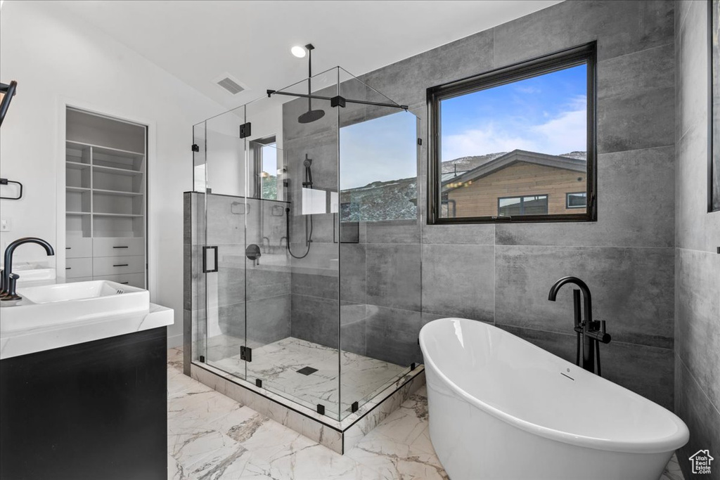 Bathroom with shower with separate bathtub and vanity