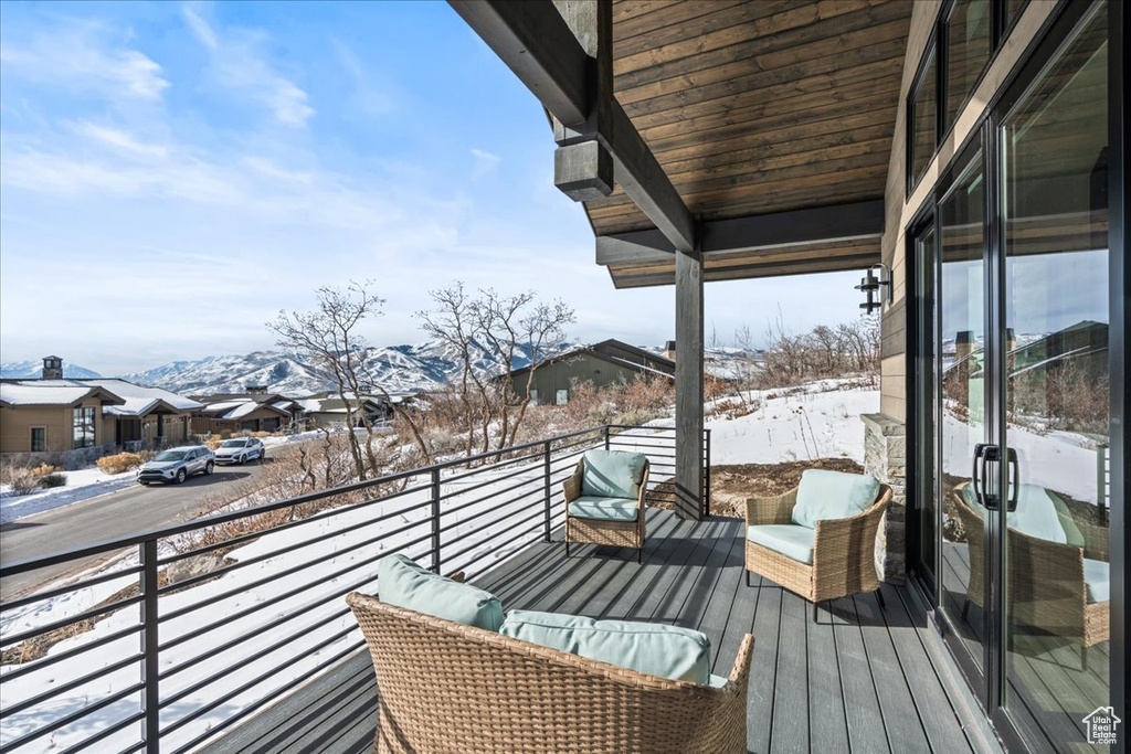 Snow covered back of property featuring a mountain view