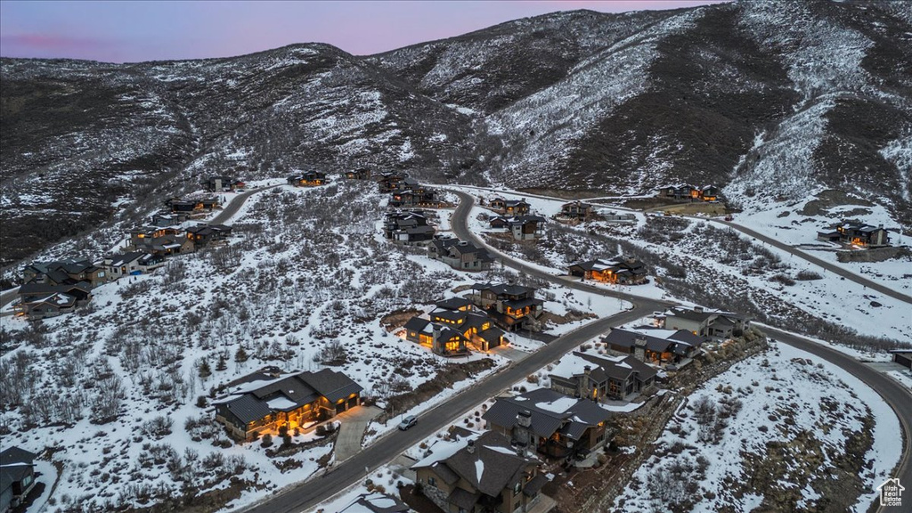 Snowy aerial view featuring a mountain view