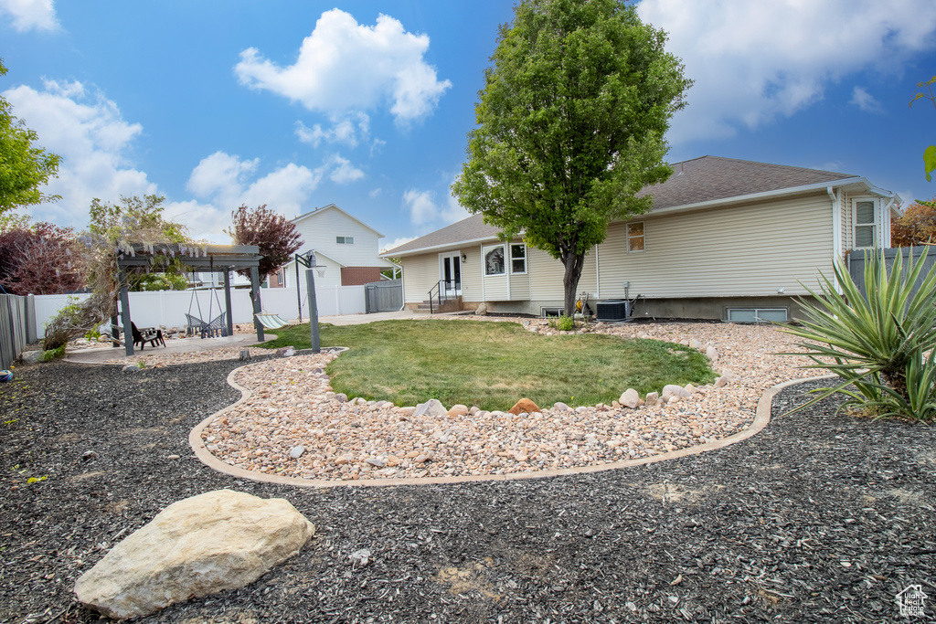 Rear view of house with a pergola, a patio, roof with shingles, and cooling unit