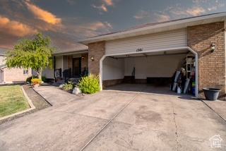 View of front of home featuring concrete driveway and brick siding