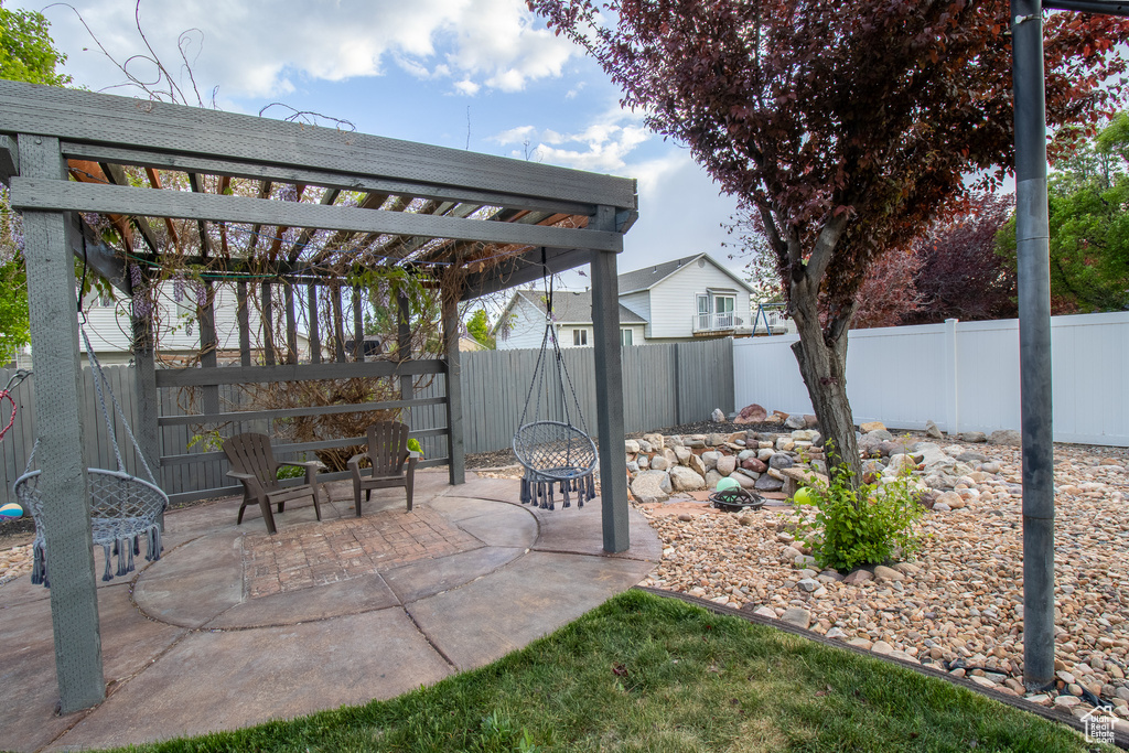 View of patio / terrace with a pergola, a fenced backyard, and a fire pit