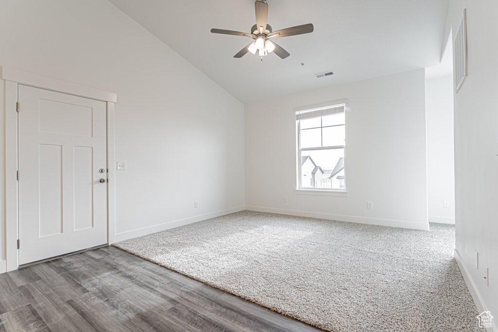 Unfurnished room featuring ceiling fan, wood finished floors, and high vaulted ceiling