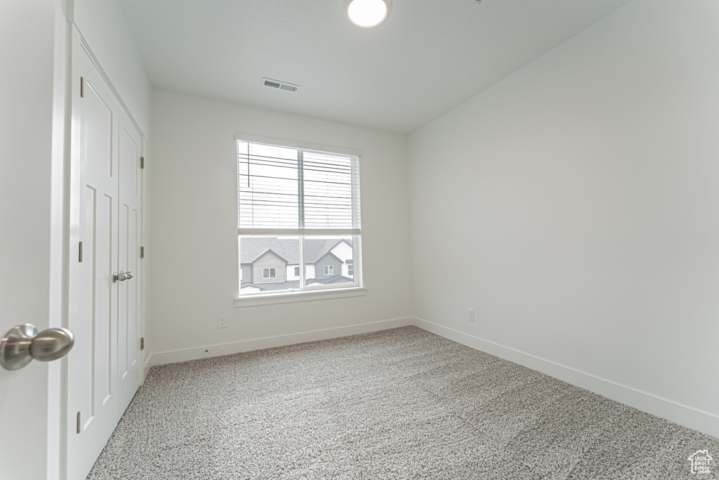 Unfurnished bedroom with baseboards and carpet flooring