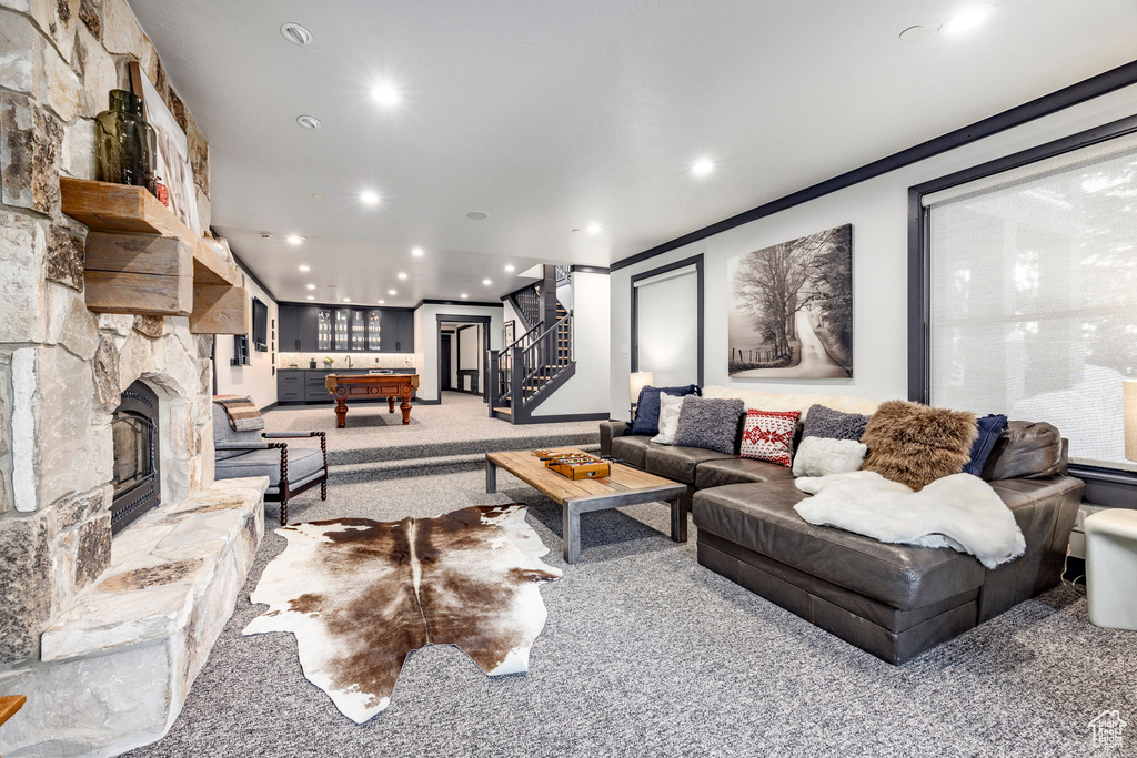 Carpeted living area with stairway, recessed lighting, pool table, and a fireplace