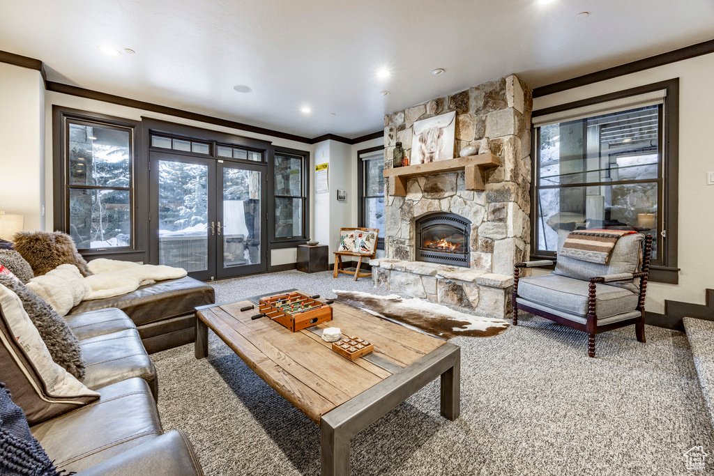 Carpeted living area featuring ornamental molding, a fireplace, recessed lighting, and baseboards