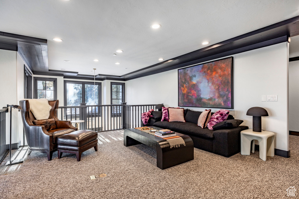 Carpeted living area with healthy amount of natural light and recessed lighting