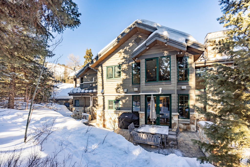 View of snow covered back of property
