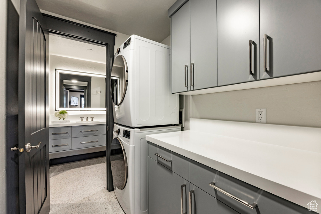 Laundry area with stacked washing machine and dryer and cabinet space