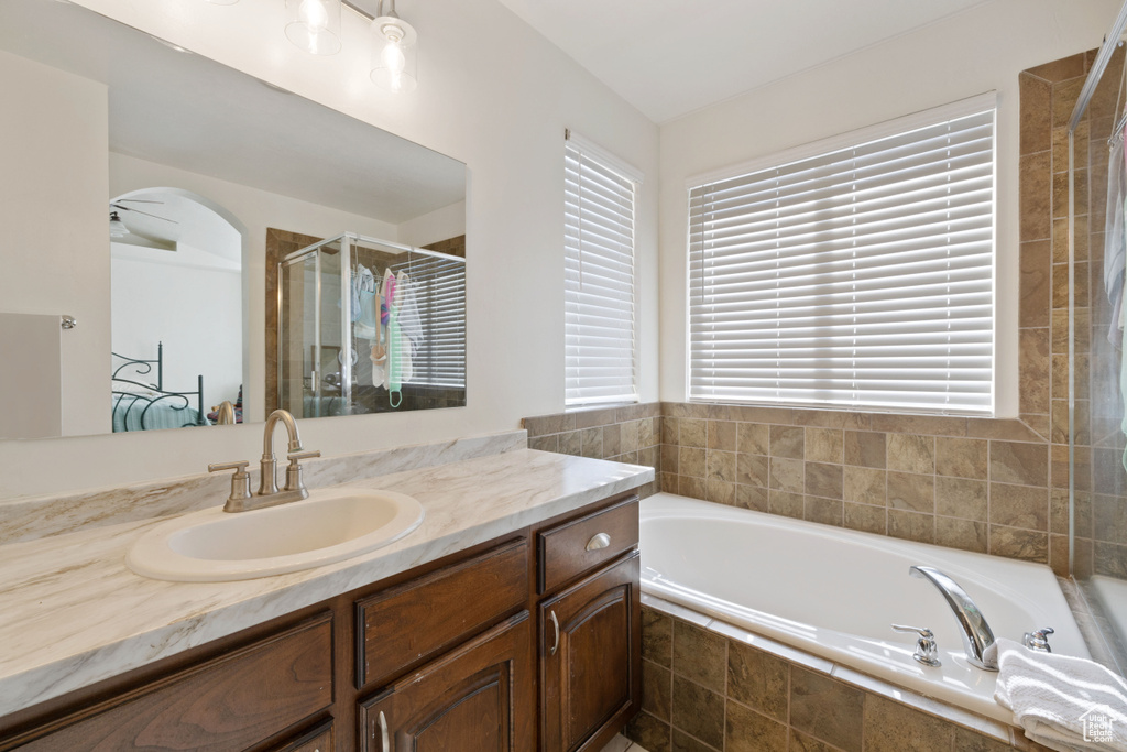 Bathroom with vanity and shower with separate bathtub