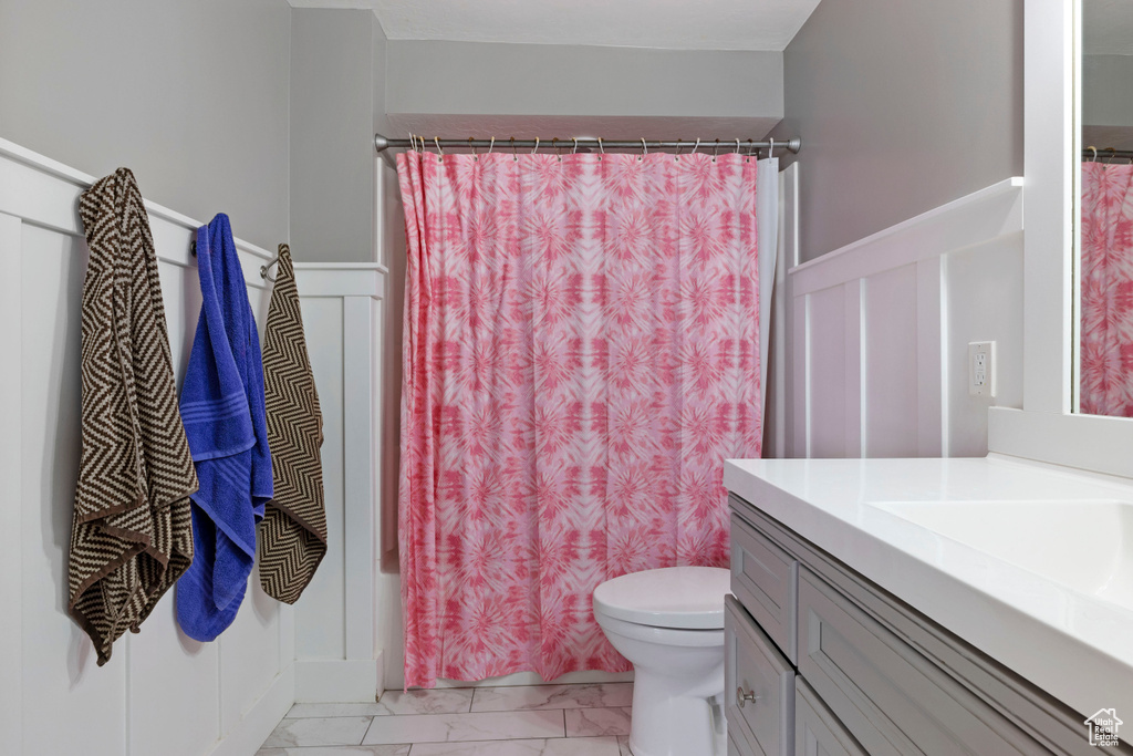 Full bathroom with vanity, toilet, and shower / bathtub combination with curtain
