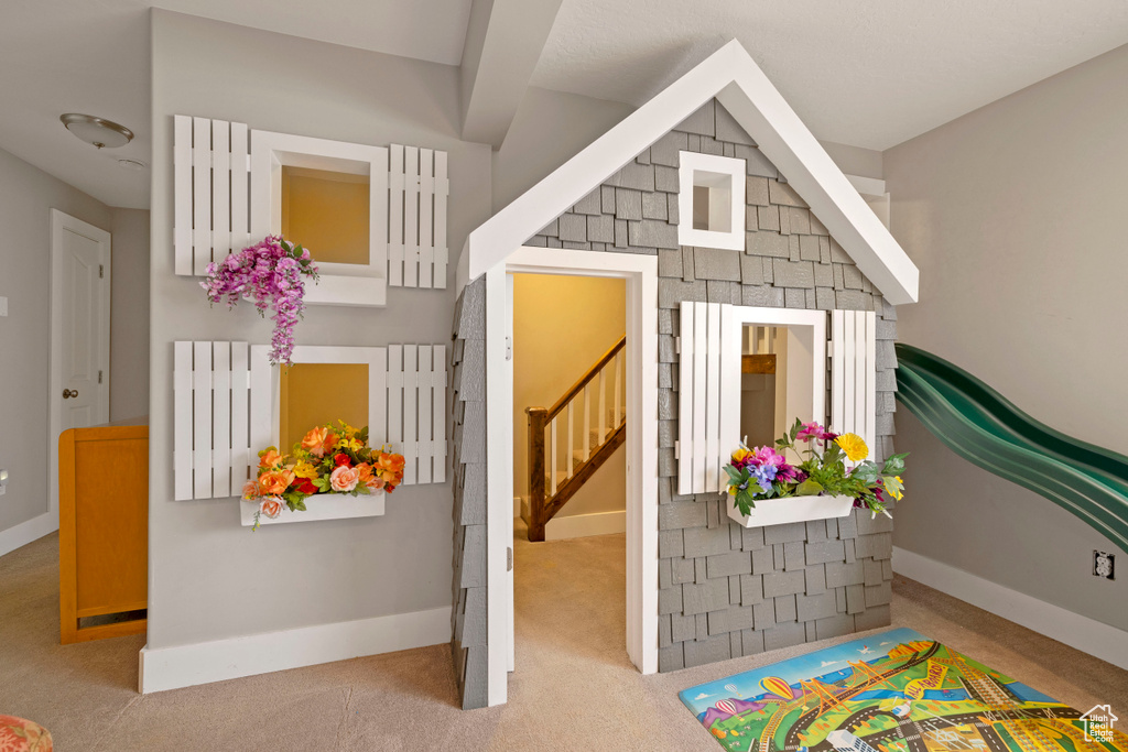 Rec room with light colored carpet