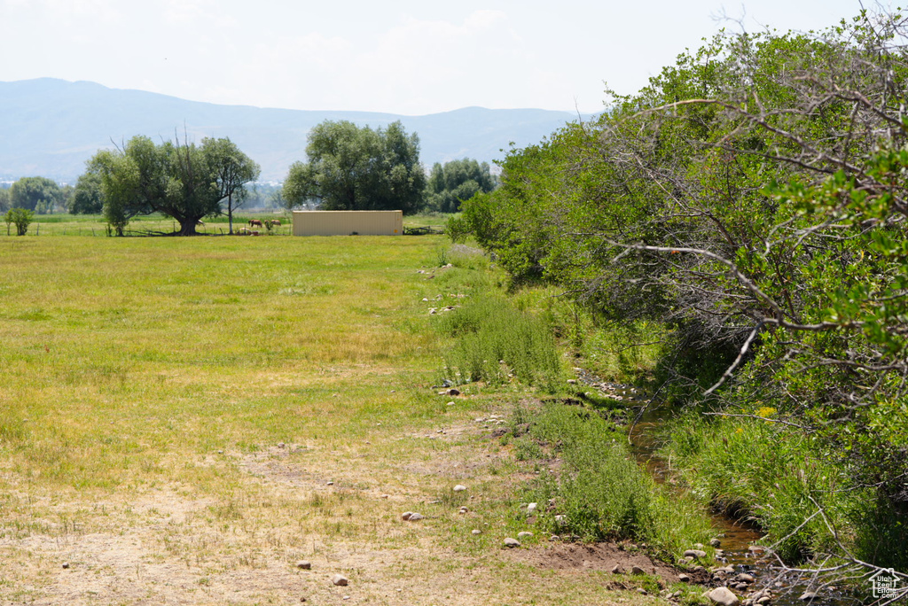 View of local wilderness featuring a rural view and a mountain view