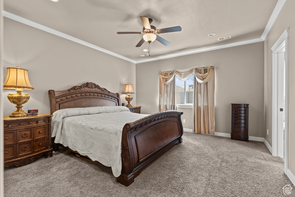 Bedroom featuring carpet, baseboards, ornamental molding, and ceiling fan