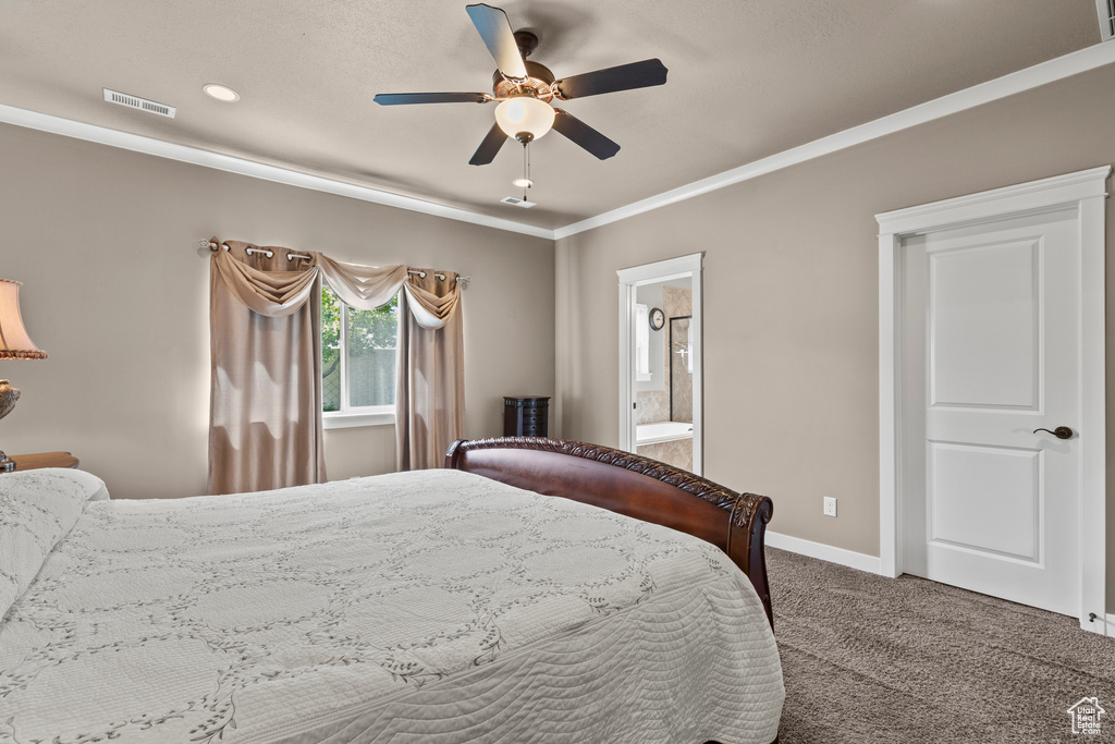 Carpeted bedroom featuring baseboards, connected bathroom, ornamental molding, and a ceiling fan