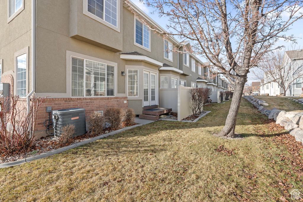 Exterior space with a lawn and central air condition unit