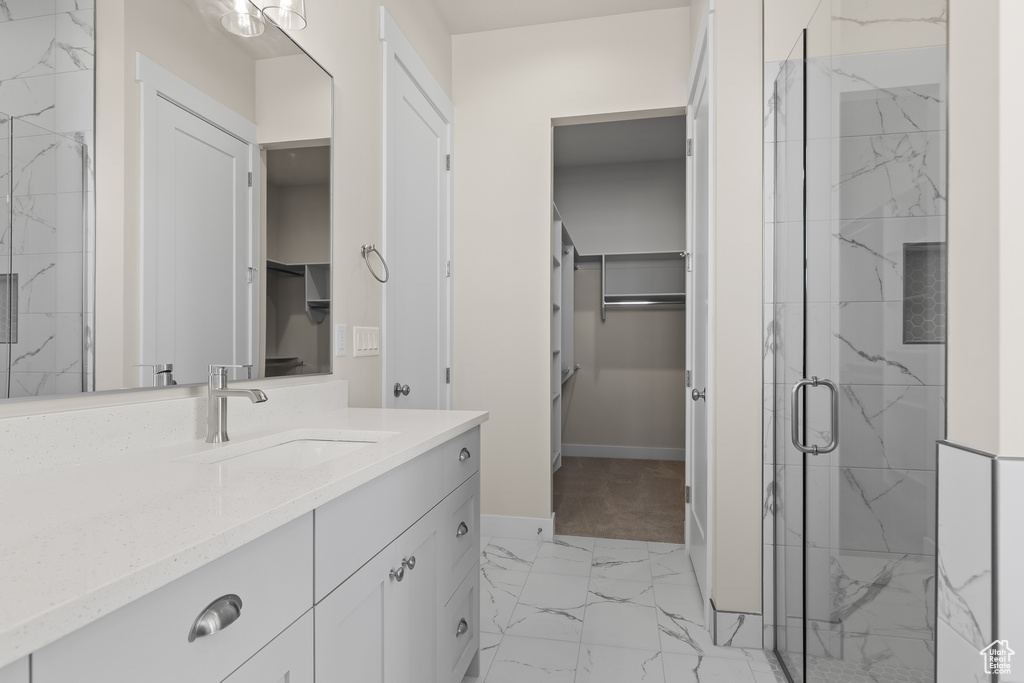 Bathroom with vanity and a shower with shower door