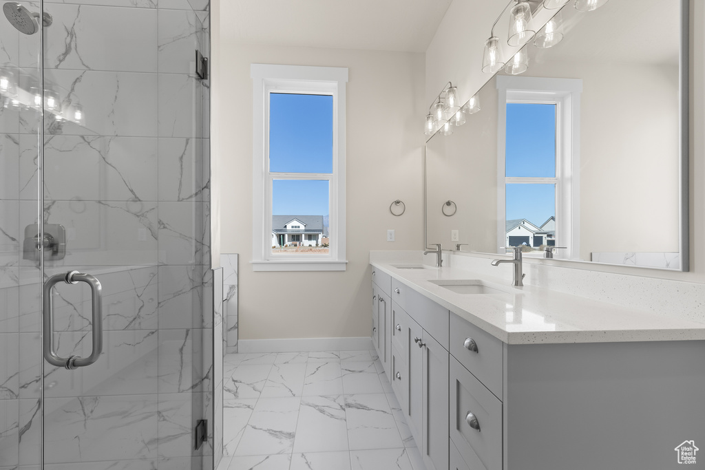 Bathroom featuring vanity and an enclosed shower