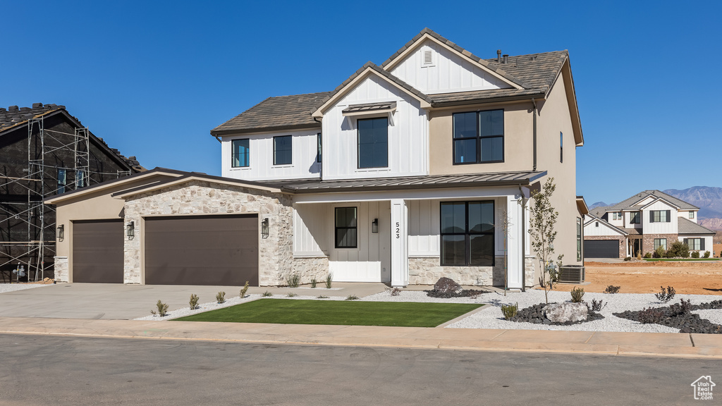 View of front facade with a garage and a porch