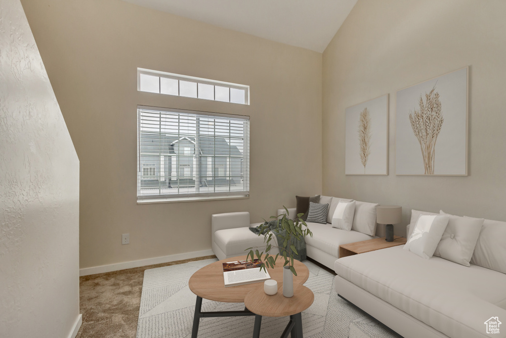 Living room with lofted ceiling, baseboards, and carpet floors