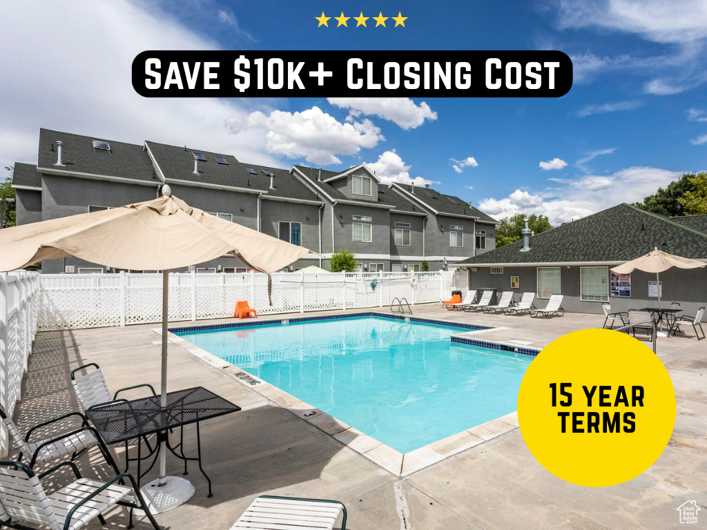 Community pool with a patio area and a residential view