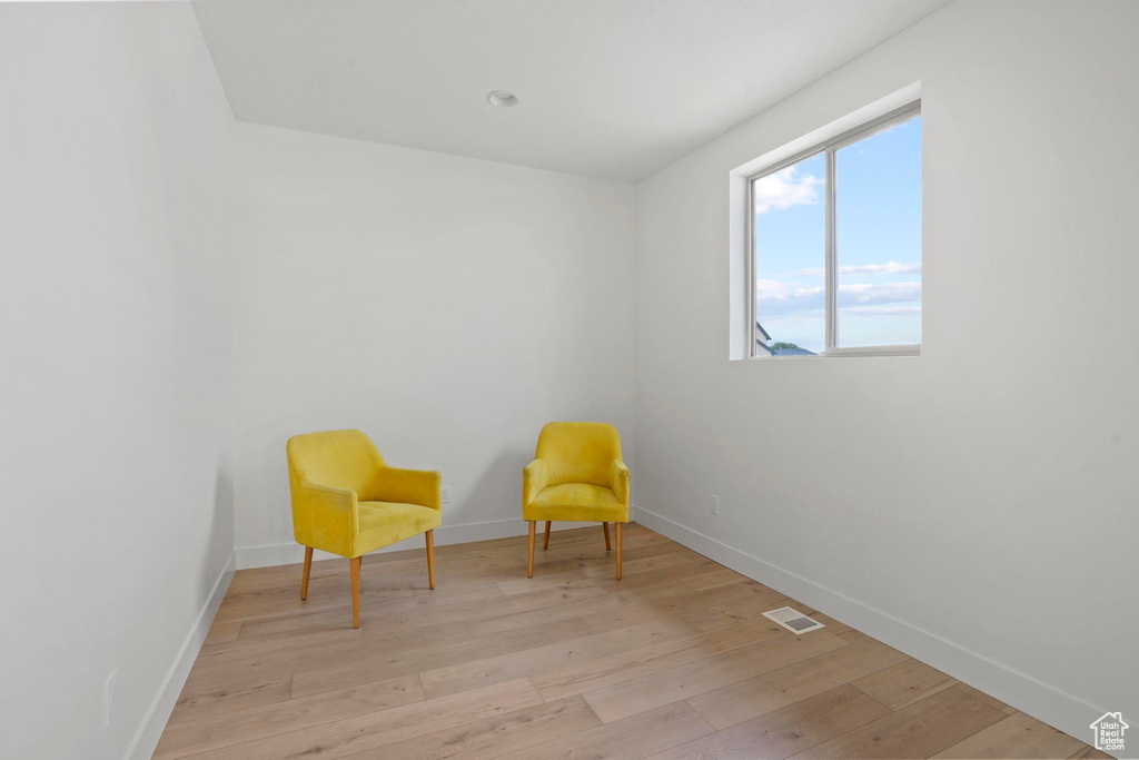 Living area with light hardwood / wood-style flooring