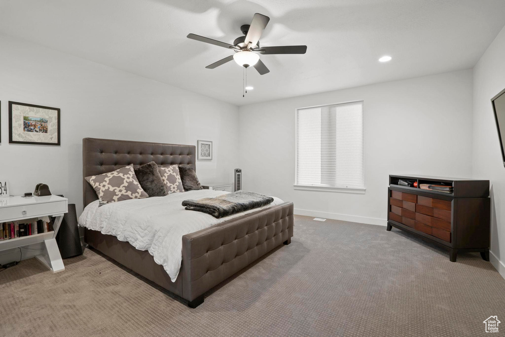 Carpeted bedroom with ceiling fan