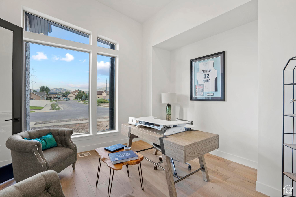 Home office with light wood-type flooring
