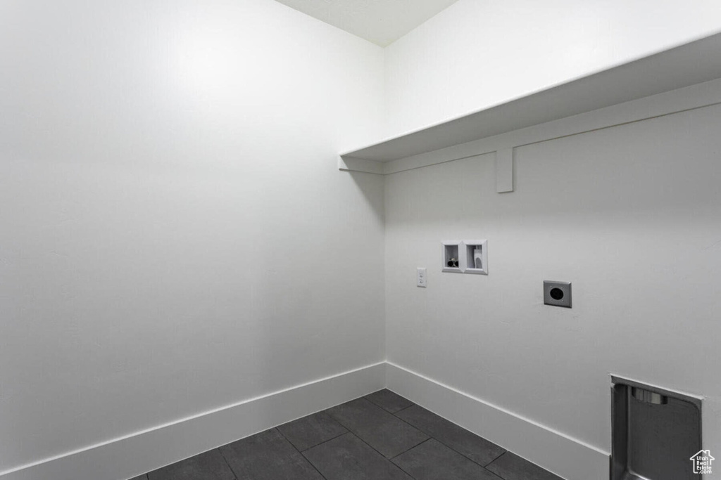 Laundry room with washer hookup, electric dryer hookup, and dark tile patterned floors