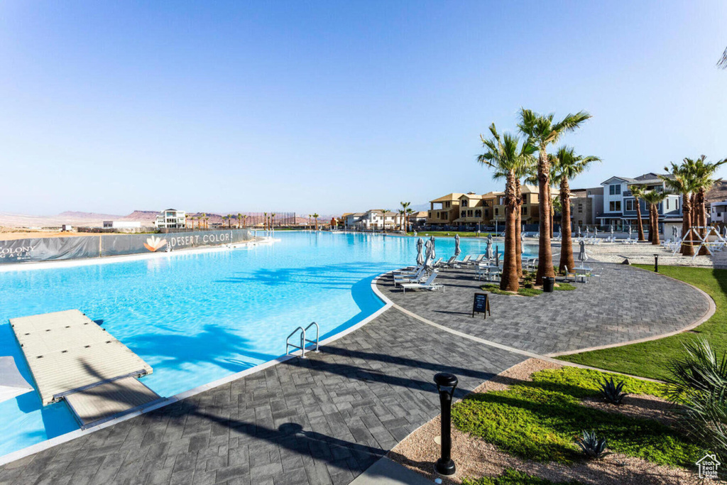 View of pool with a patio area and a water view
