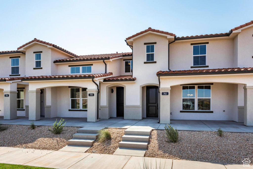 Mediterranean / spanish-style house with a patio area