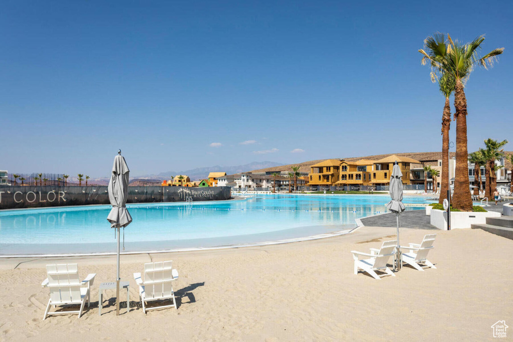View of pool with a beach view