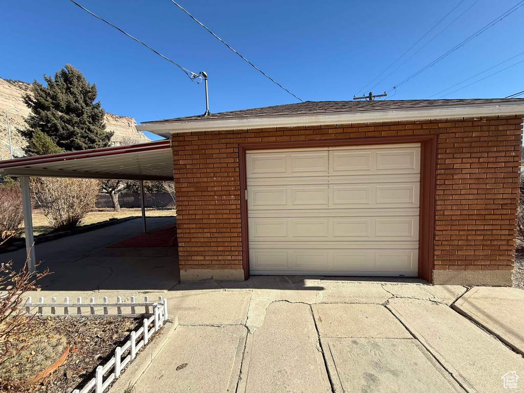 Garage featuring a carport