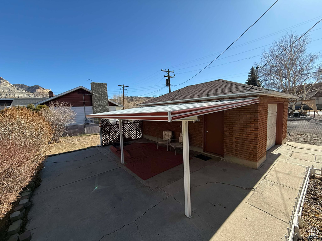 Rear view of property with a garage