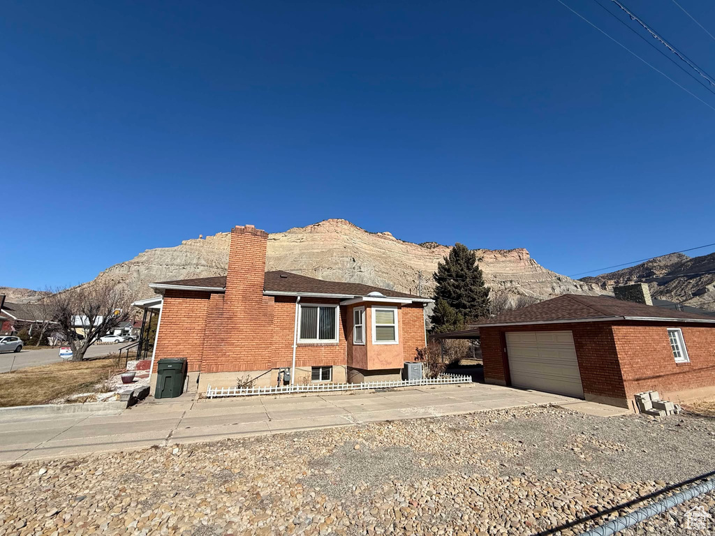 View of front facade with a mountain view and a garage