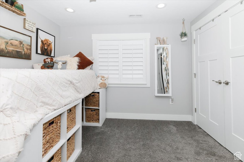 Unfurnished bedroom featuring dark colored carpet