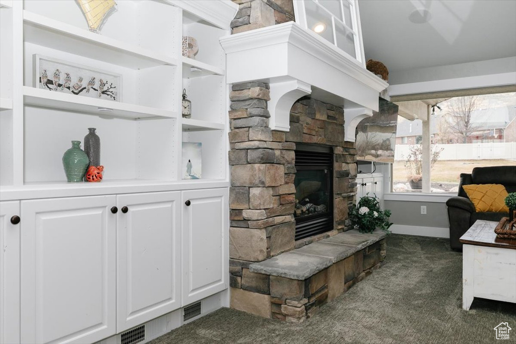 Carpeted living room with a fireplace