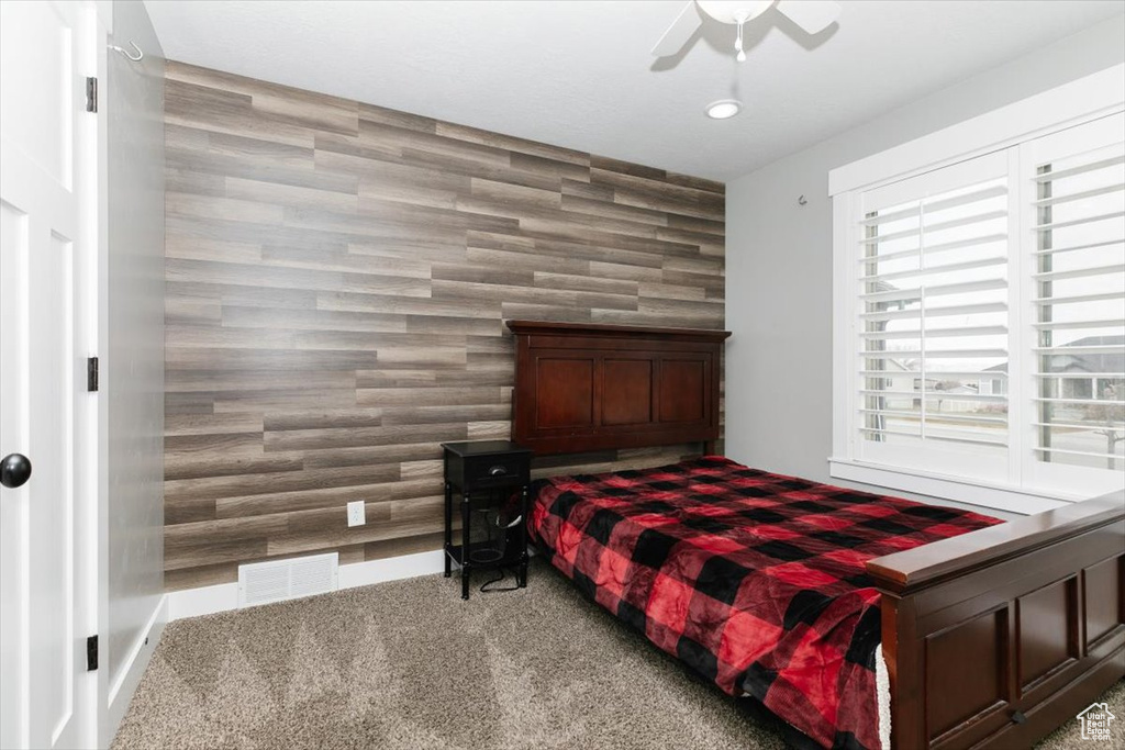 Bedroom featuring ceiling fan and carpet