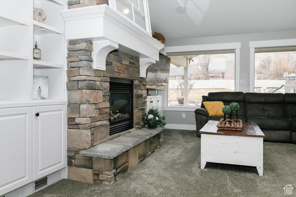 Carpeted living room with a fireplace