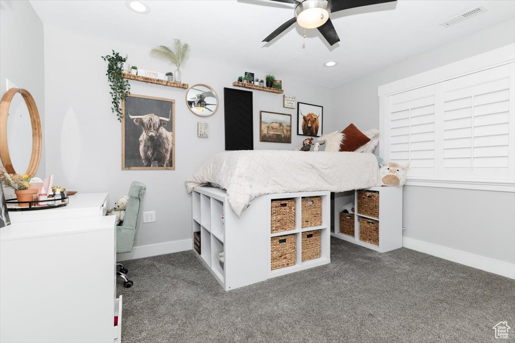 Bedroom featuring dark colored carpet