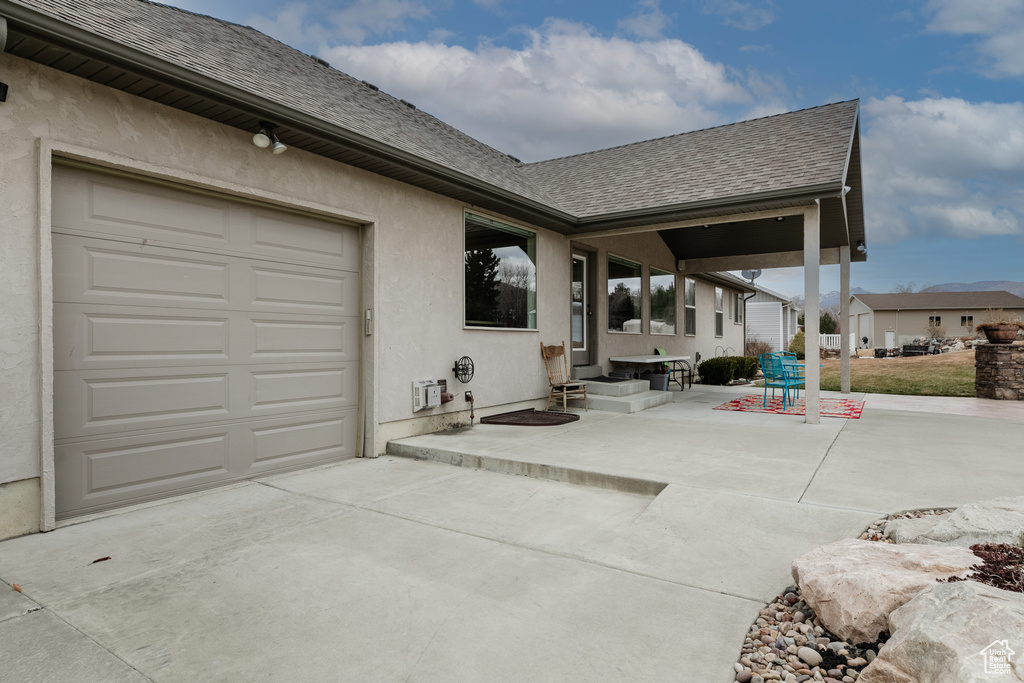 View of patio / terrace featuring a garage