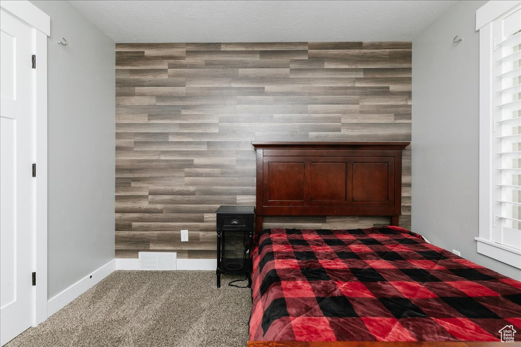 Unfurnished bedroom featuring carpet flooring and a textured ceiling