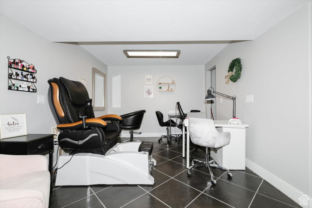 Office with dark tile patterned flooring