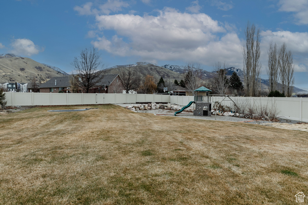 View of yard featuring a mountain view and a playground