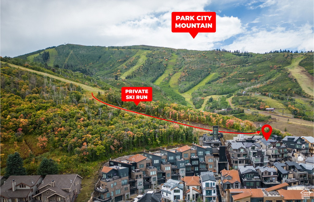 View of property location featuring mountains and a heavily wooded area