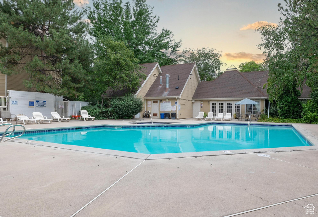 Pool at dusk with a patio area