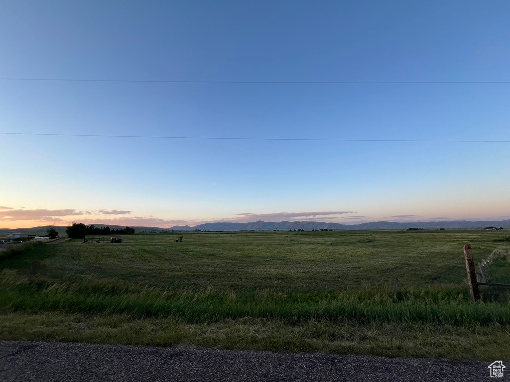 Yard at dusk featuring a rural view