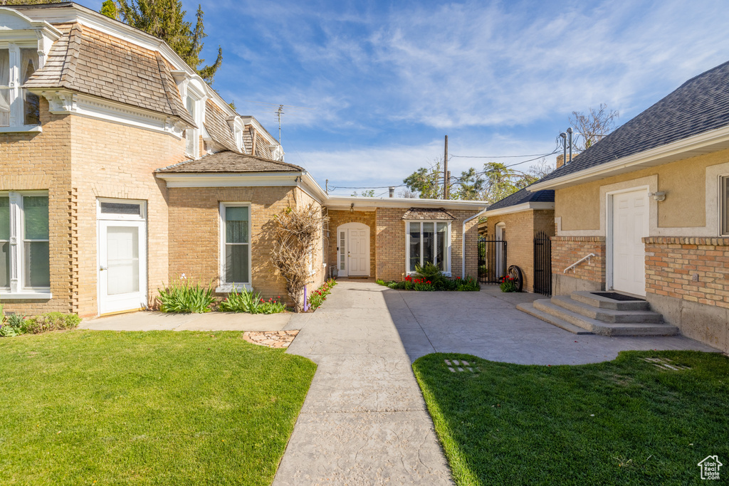 Exterior space featuring a patio and a front yard